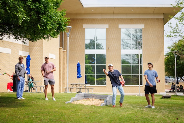 A group of students playing Horseshoes on the Union grounds.